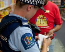 A police officer takes a statement at a crime scene