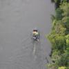 The Police helicopter flies over a Police launch searching the Waikato River