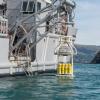 The diving Wet Bell is lowered in to the waters of Akaroa Harbour from the Royal New Zealand Navy HMNZS MANAWANUI 