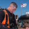 Navy diver PODI Leeroy Coleman from the Royal New Zealand Navy (RNZN) Operational Dive Team (ODT) dons his equipment 