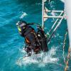 Navy diver ADR Kyran Bennett from the Royal New Zealand Navy (RNZN) Operational Dive Team enters the water in Akaroa Harbour