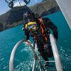 Navy diver ADR Luke Gordon from the Royal New Zealand Navy Operational Dive Team climbs back on board the HMNZS MANAWANUI