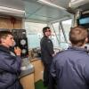 Members of the Royal New Zealand Navy Operational Dive Team monitor divers in the water from the 'Dive Shack' on HMNZS MANAWANUI