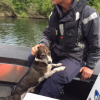 Sergeant Craig Kennedy and the dog rescued from the Waikato River