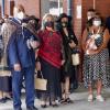 Warwick and his wife Leeanne Morehu (in red) and other members of his whanau wait to be welcomed