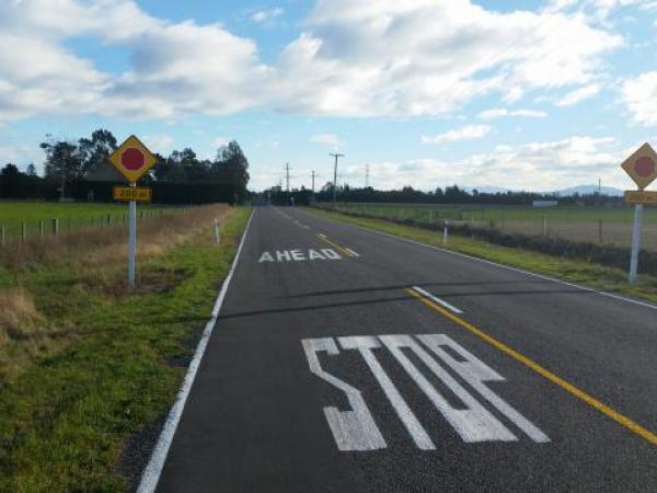 Stop sign controlled intersection - Johns Rd and Plasketts Rd looking west