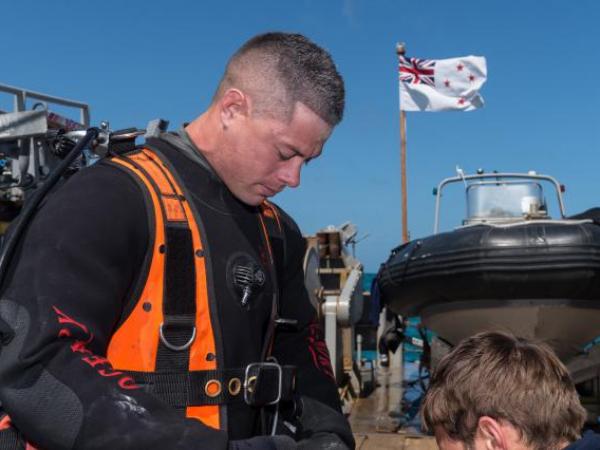 Navy diver PODI Leeroy Coleman from the Royal New Zealand Navy (RNZN) Operational Dive Team (ODT) dons his equipment 