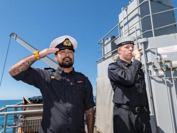 Members of the diving support vessel HMNZS MANAWANUI performing a ‘Piping of the Side’ as a mark of respect