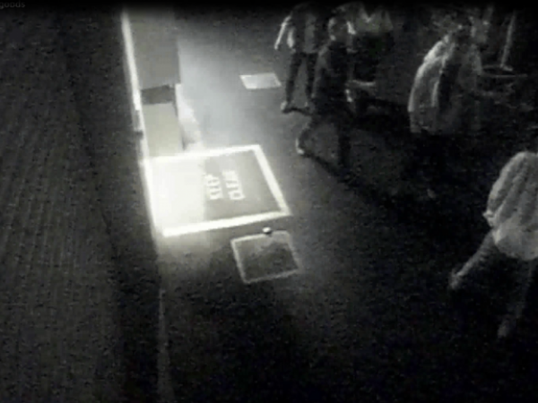 The alleged offender is the man in the top right, facing the camera with his shirt unbuttoned.