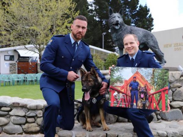 Constable Seaton McGuigan (right), Dunedin Police, and his winning Police Dog Trust calendar entry with the image stars, Constab