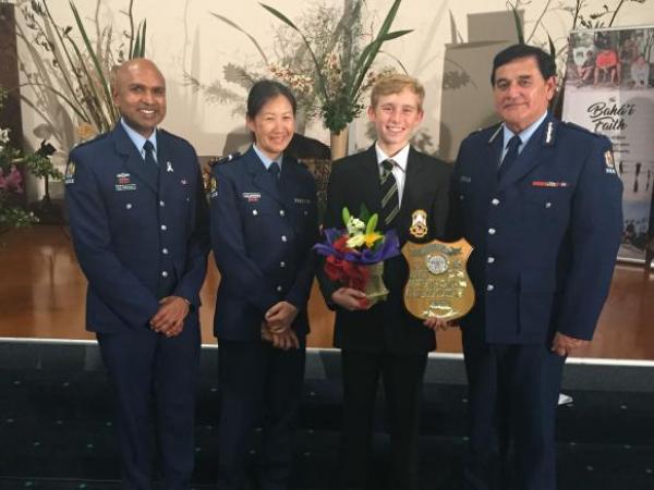 Inspector Rakesh Naidoo, Senior Constable Elizabeth Young and Deputy Commissioner Haumaha with the winner, Robbie White