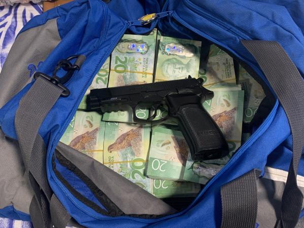 Cash and an air pistol recovered during a search warrant