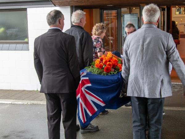 The Police flag and a bouquet adorned Jos's Police blue coffin. 