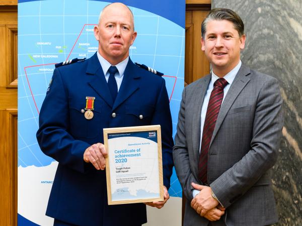 Sergeant Toby Officer receives his award from Transport Minister Michael Wood.