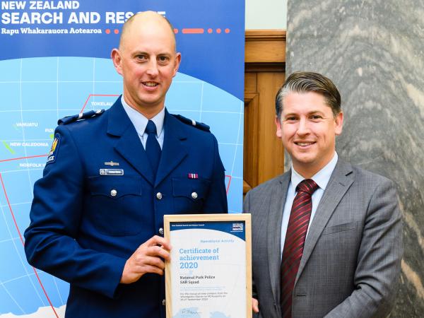  Senior Constable Conrad Smith receives his award from Transport Minister Michael Wood.