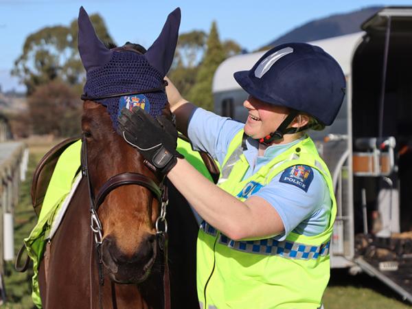 Constable Ashleigh Smail adjusts Lulu's ear bonnets.