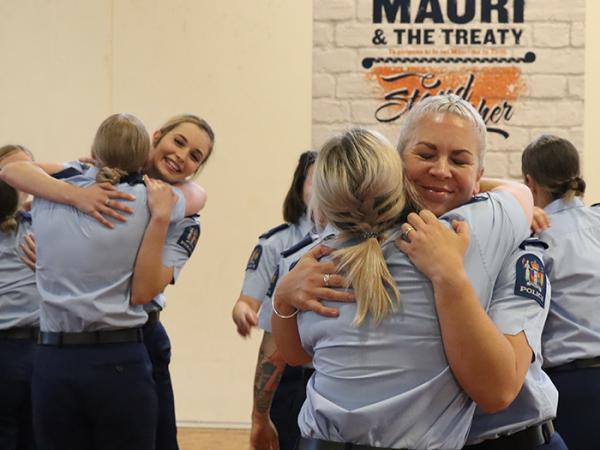 Some of the newly graduated constables hugging