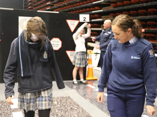 Constable Gemma Hyde helps a student trying out the fatal vision googles.