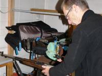 Waikato Arms Officer Richard Plas examines a recovered firearm