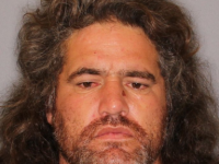 Darren Millar has a warrant for his arrest on assault charges