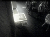 The alleged offender is the man in the top right, facing the camera with his shirt unbuttoned.