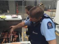 Senior Sergeant Mike Stevenson multi-tasks, taking a call while manning the BBQ.