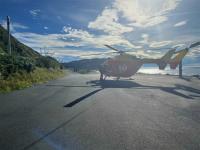 The Westpac Rescue Helicopter waits to take the man to hospital after his fall.
